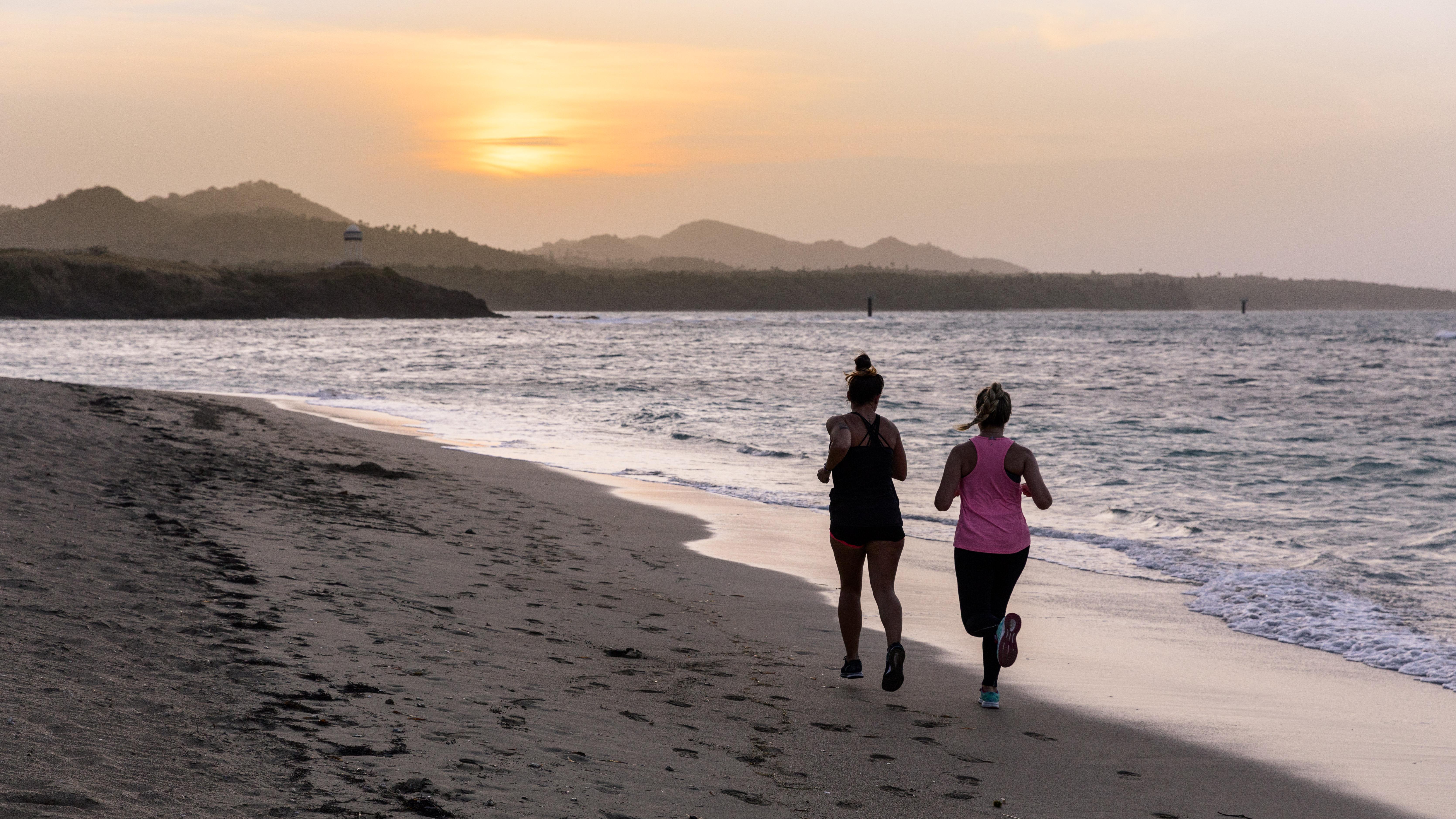 Playabachata Puerto Plata Exterior photo Joggers on the beach at sunset